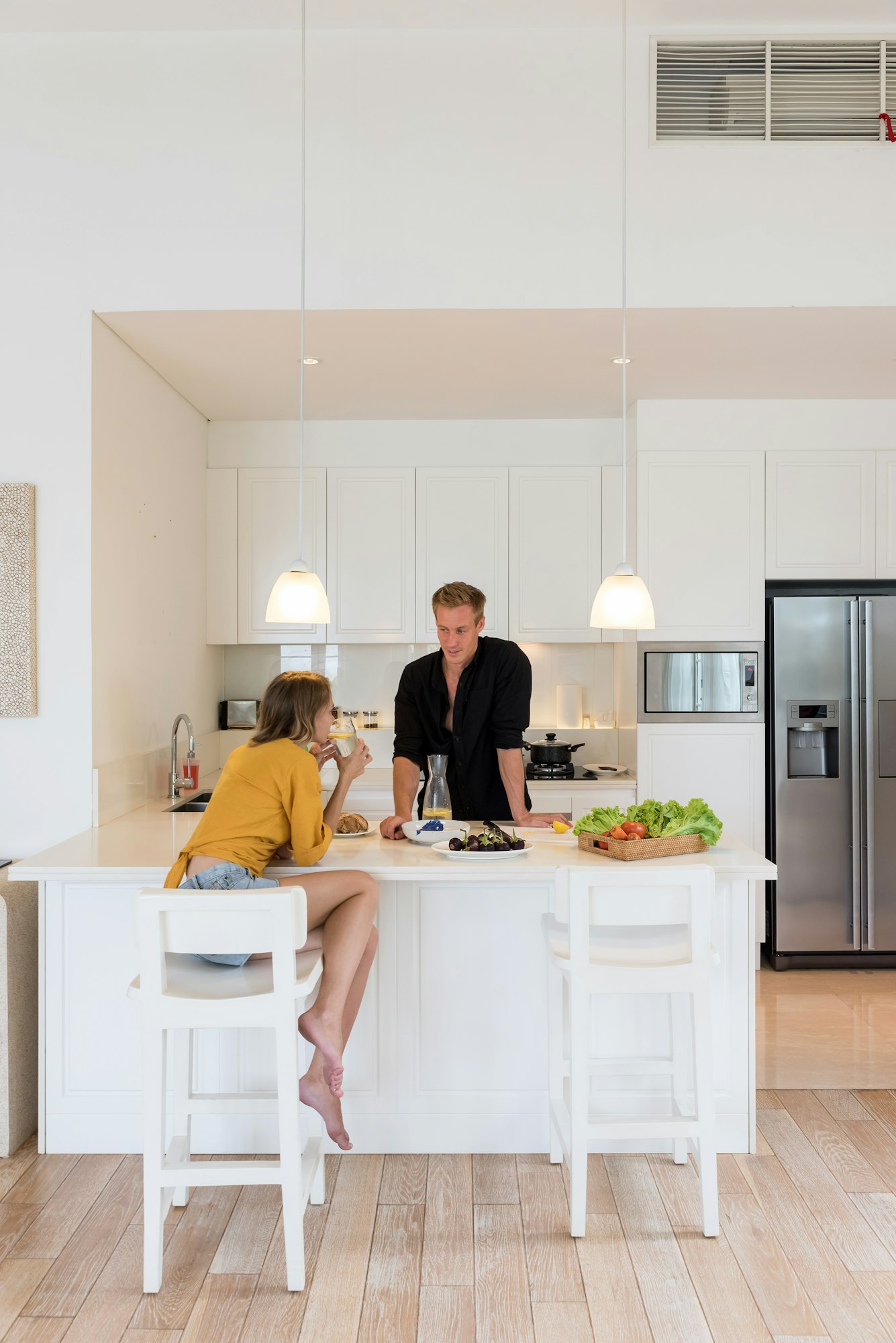 Couple making lunch on a white kitchen at home