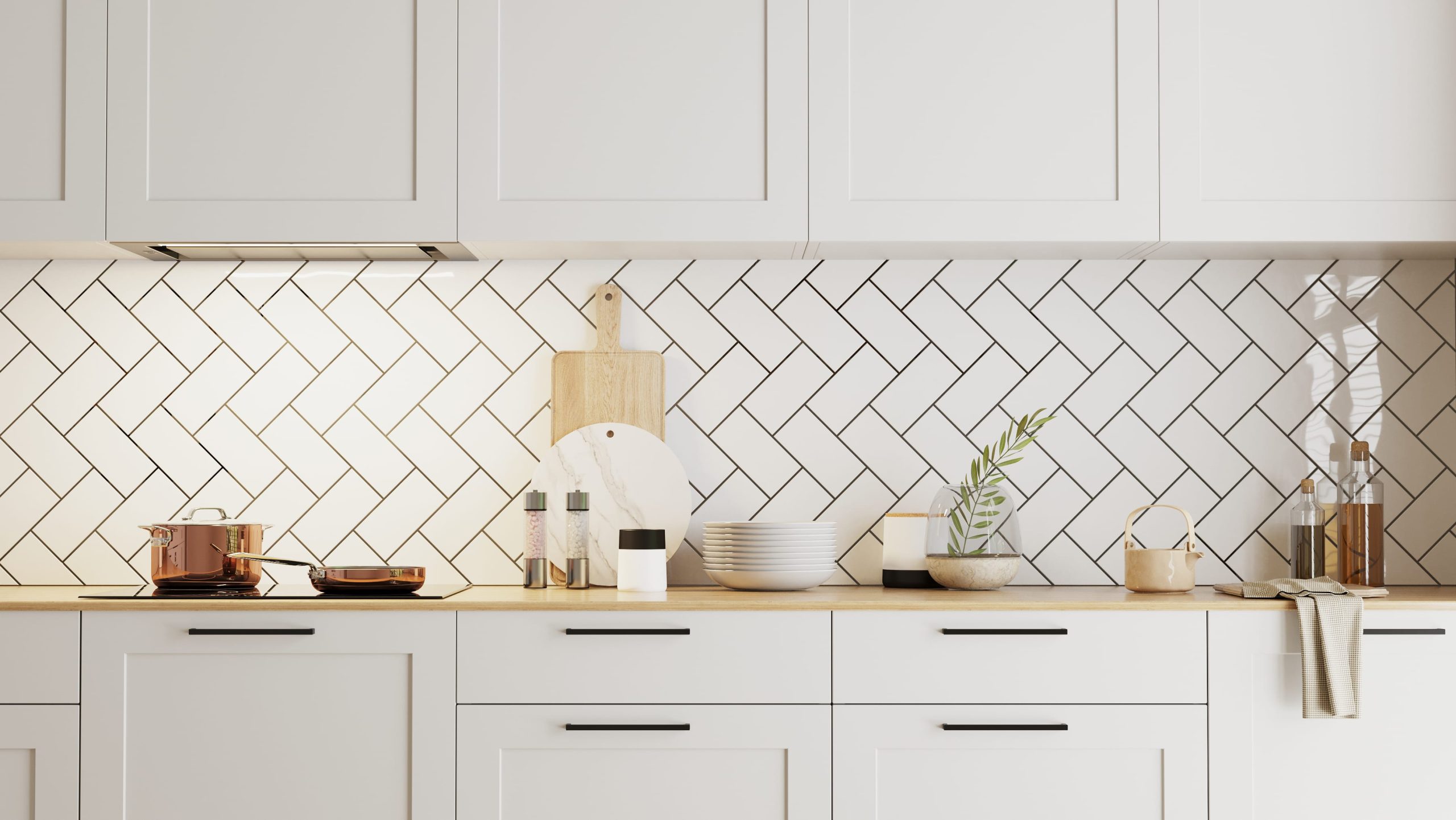 A crisp, white kitchen with a subway tile splashback, laid in a herringbone fashion.